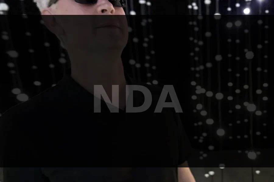 Senior engineer with high-end equipment rack